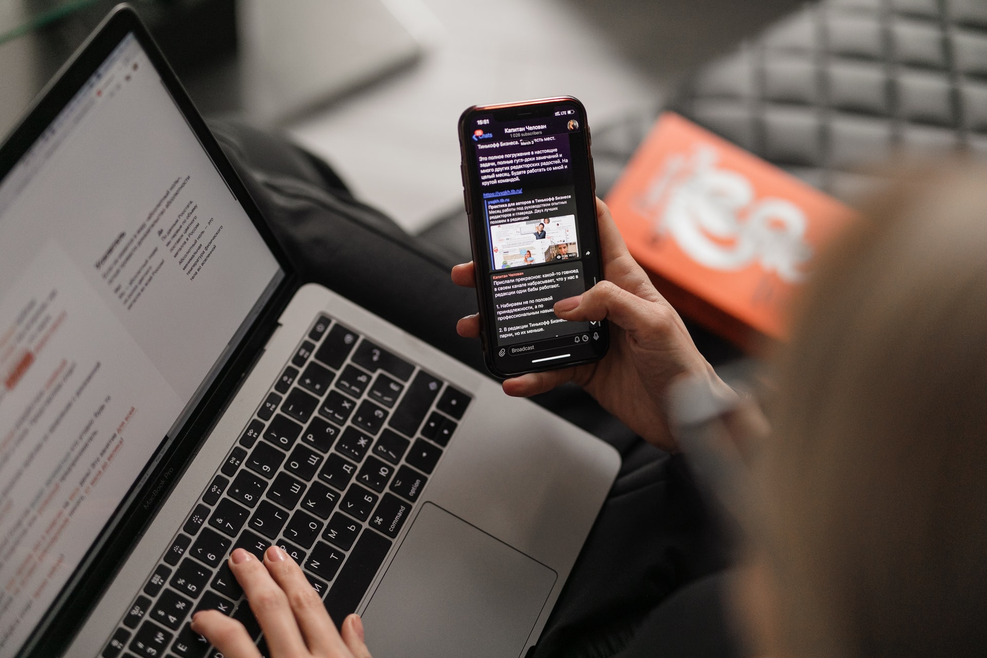 user looking at social media on phone and laptop